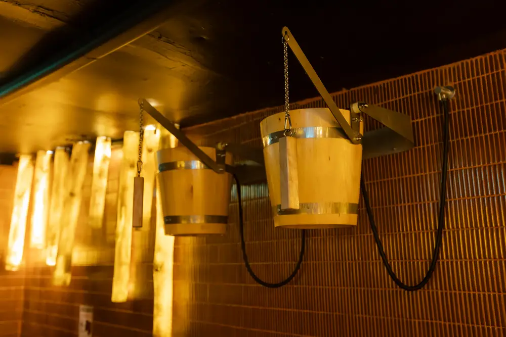 Overhead wooden cold bucket on a chain at Wellmax gay sauna, Bangkok